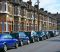 DMK9DT Typical East London terraced housing with residents car parking spaces in street